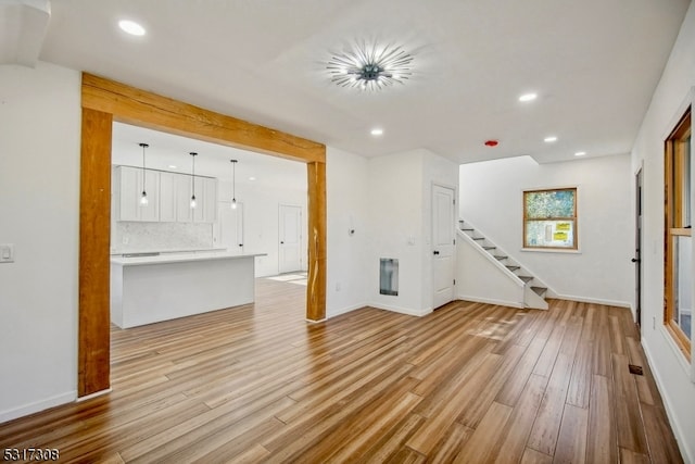 unfurnished living room with light wood-type flooring