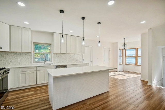 kitchen featuring a wealth of natural light, a kitchen island, and hardwood / wood-style floors