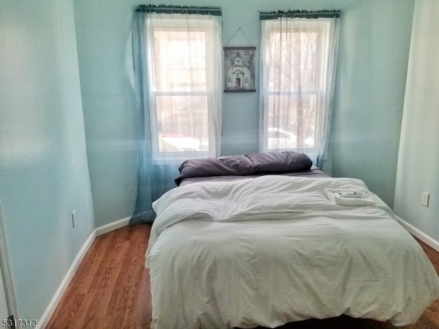 bedroom with hardwood / wood-style floors