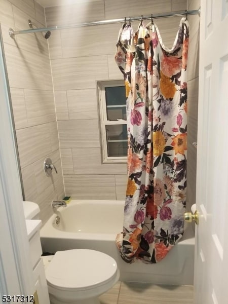 full bathroom featuring vanity, shower / bath combo, and toilet