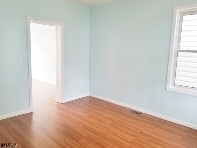 empty room with light hardwood / wood-style floors