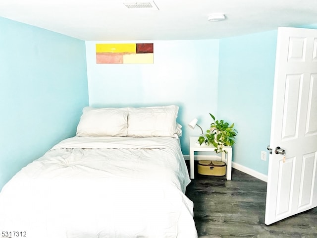 bedroom featuring dark wood-type flooring