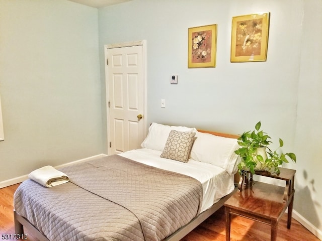 bedroom with hardwood / wood-style flooring