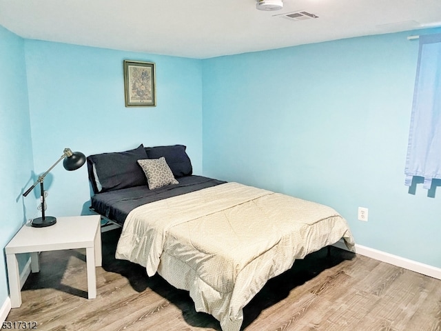 bedroom with light hardwood / wood-style floors