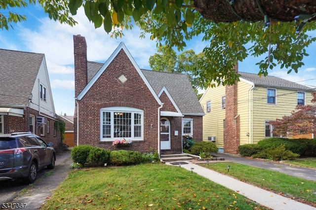 bungalow-style home with a front lawn