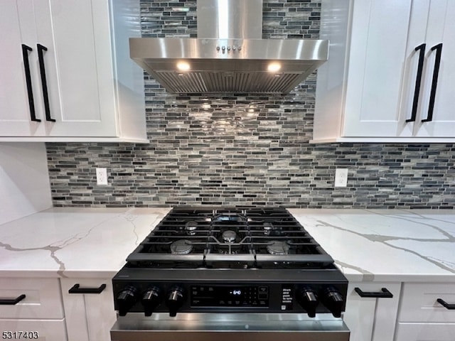 kitchen with white cabinets, stainless steel range, wall chimney range hood, and tasteful backsplash