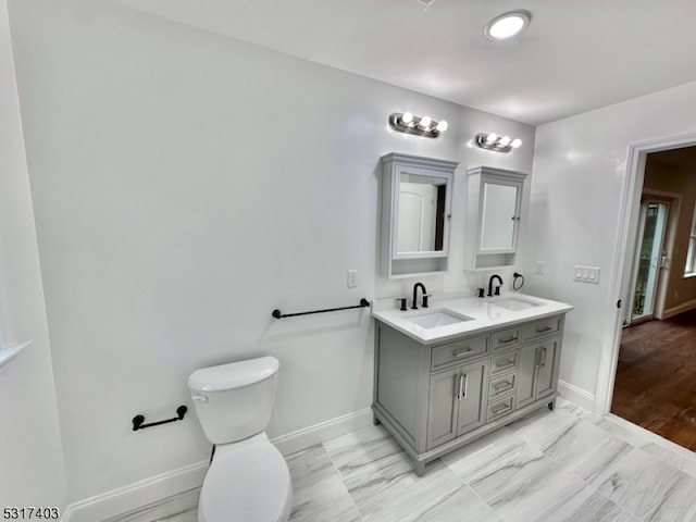 bathroom with hardwood / wood-style floors, vanity, and toilet