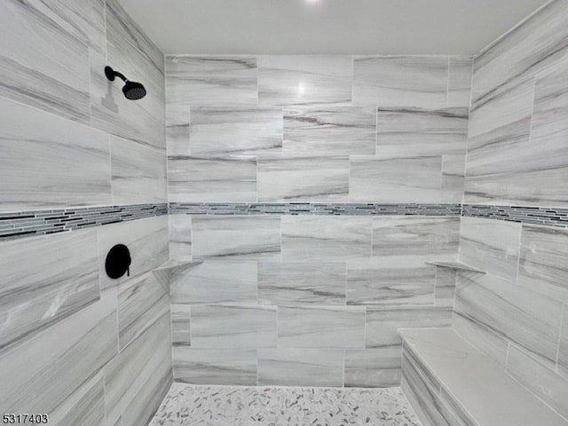 bathroom featuring a tile shower