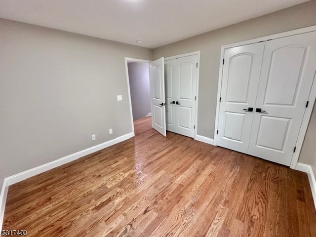 unfurnished bedroom with light wood-type flooring