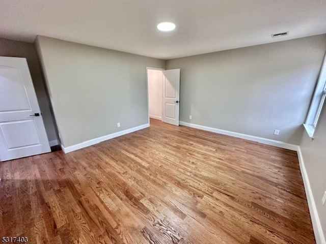 unfurnished bedroom featuring hardwood / wood-style flooring