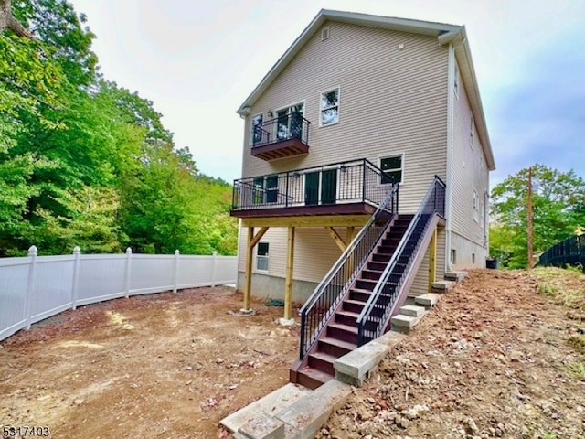 back of property with a wooden deck