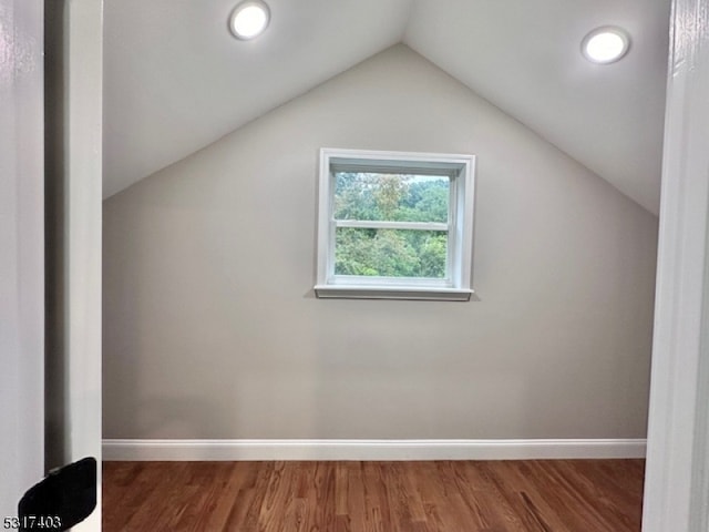 bonus room with lofted ceiling and hardwood / wood-style flooring