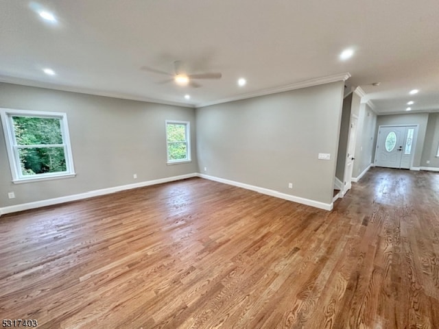 unfurnished room with wood-type flooring, ceiling fan, and crown molding