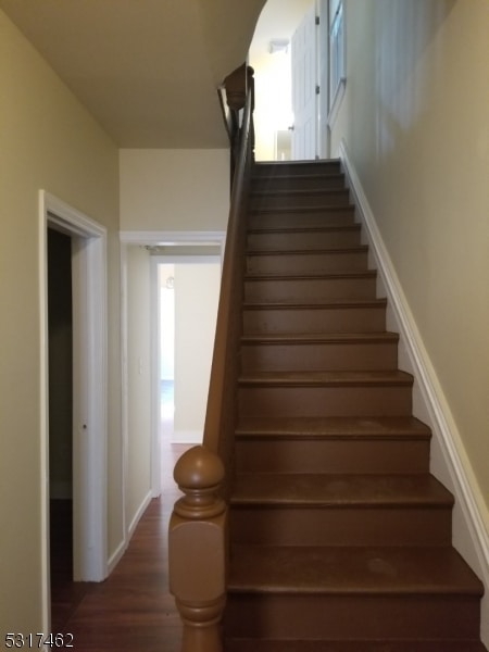 stairs with hardwood / wood-style flooring