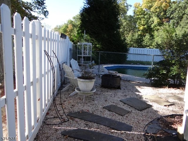 view of yard with a fenced in pool and a fenced backyard