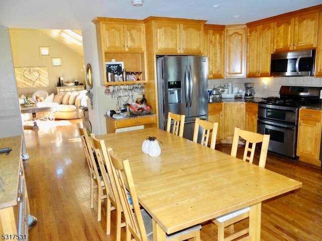 kitchen featuring stainless steel appliances, tasteful backsplash, and wood finished floors