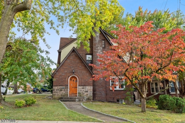 tudor house featuring a front lawn