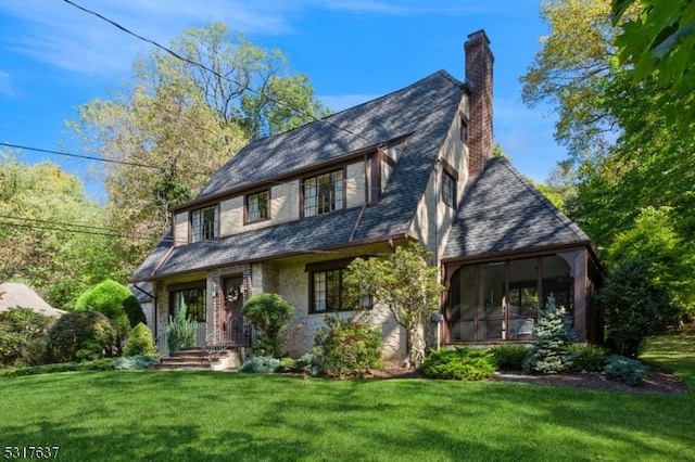 view of front of house featuring a front yard and a sunroom