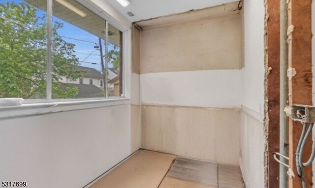 unfurnished sunroom with a wealth of natural light