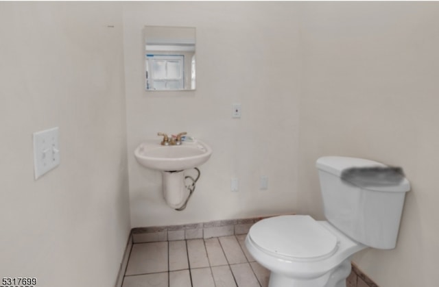 bathroom with toilet and tile patterned floors