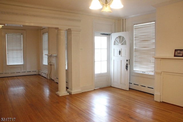 entryway with plenty of natural light, light hardwood / wood-style floors, and a baseboard heating unit