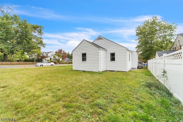 rear view of property featuring a lawn