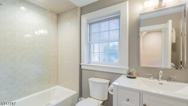 full bathroom featuring toilet, vanity, and tiled shower / bath