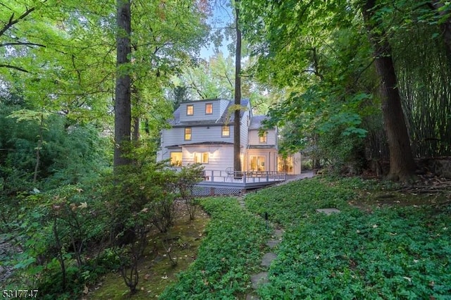 back of property featuring a wooden deck