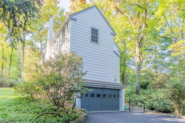 view of side of home featuring a garage