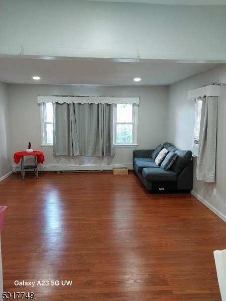 unfurnished room with hardwood / wood-style flooring and plenty of natural light