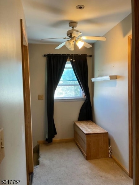 unfurnished bedroom featuring light carpet and ceiling fan