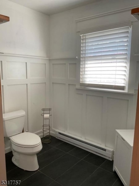 bathroom featuring vanity, a baseboard radiator, toilet, and tile patterned flooring