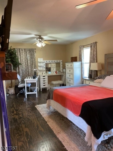 bedroom featuring ceiling fan and dark hardwood / wood-style flooring