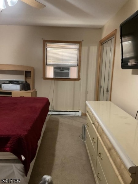 bedroom featuring ceiling fan, light carpet, cooling unit, and a baseboard radiator