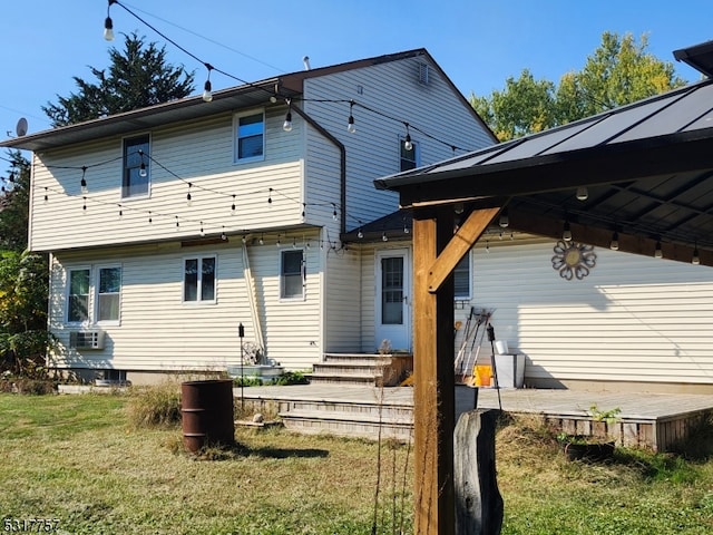 rear view of property with a lawn