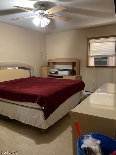 carpeted bedroom featuring a baseboard heating unit, cooling unit, and ceiling fan