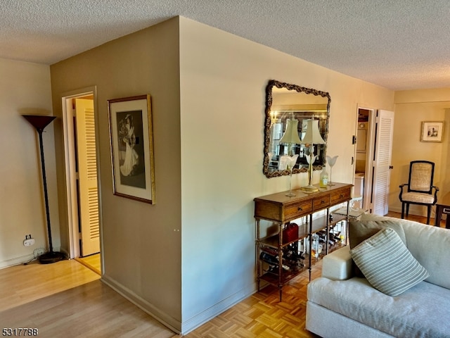 living room with a textured ceiling and light parquet floors