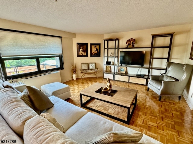 living room featuring parquet flooring and a textured ceiling