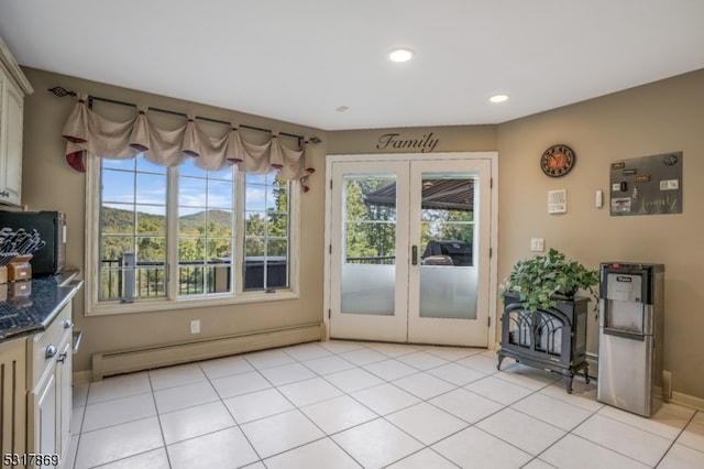 entryway with french doors, a baseboard radiator, and light tile patterned floors