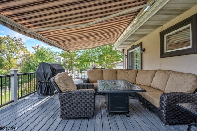 deck with an outdoor living space with a fire pit