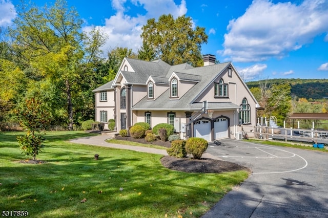 view of front of property featuring a garage and a front lawn