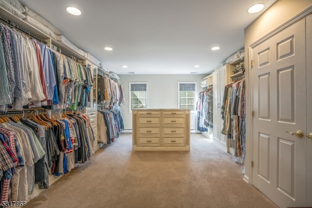 walk in closet featuring light carpet