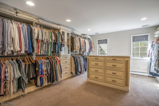 walk in closet featuring light colored carpet and baseboard heating