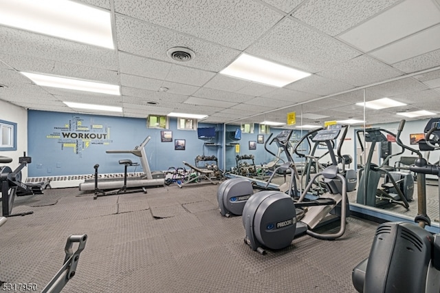 gym featuring a drop ceiling and carpet flooring