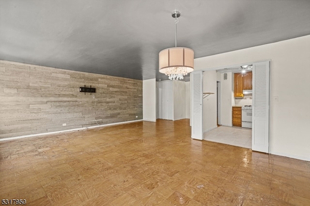 unfurnished dining area with an inviting chandelier