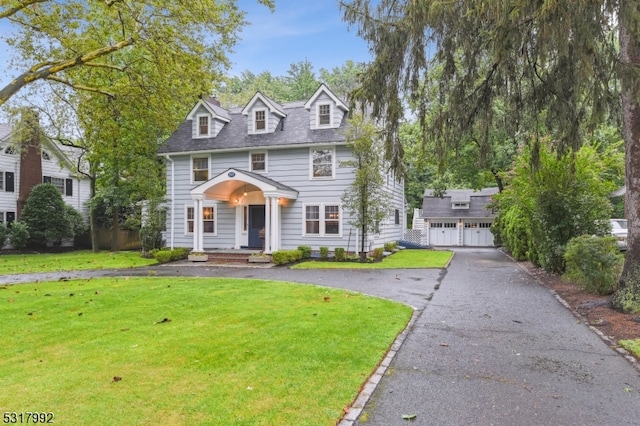 view of front of house with a front lawn and a garage