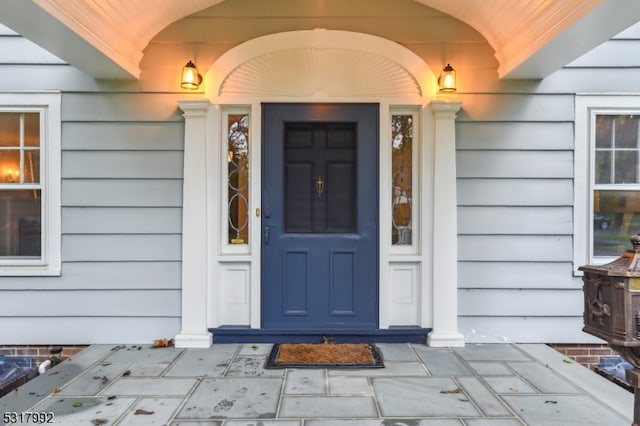 view of exterior entry with a porch