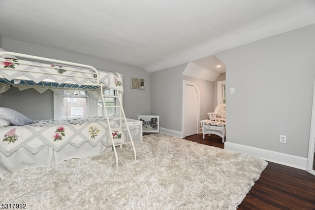 bedroom featuring vaulted ceiling and wood-type flooring