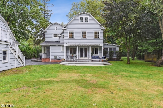 rear view of property with a lawn