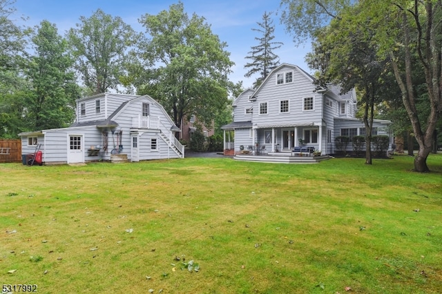 back of house featuring a yard and a patio